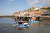 Thumbnail image of boats in Whitby Harbour with the Old Town and Church of Saint Mary, Yorkshire, England