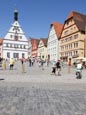 Tourists Walking By Typical Buildings On The Marktplatz  Market Square, Rothenburg Ob Der Tauber, Fr