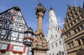 Pillar On Georges Spring With The Town Hall Tower, Rothenburg Ob Der Tauber, Franconia, Bavaria, Ger
